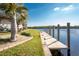Waterfront backyard featuring a long concrete dock with direct access to serene, wide canal at 1339 Casey Key Dr, Punta Gorda, FL 33950