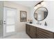 Stylish bathroom with modern vanity, decorative mirror, and access to the outdoors, offering convenience and style at 1339 Casey Key Dr, Punta Gorda, FL 33950