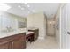 Bright bathroom featuring dual sinks, granite counters, large mirror, and a walk-in shower at 1339 Casey Key Dr, Punta Gorda, FL 33950