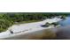 Aerial view of a sandy beach with trees, walking paths, and waterfront views at 1339 Casey Key Dr, Punta Gorda, FL 33950