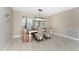Charming dining room with natural lighting, a modern chandelier, and stylish decor at 1339 Casey Key Dr, Punta Gorda, FL 33950