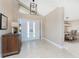 Bright foyer featuring double doors, a decorative light fixture, and tile flooring at 1339 Casey Key Dr, Punta Gorda, FL 33950