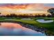 Picturesque golf course view with sand traps and water features under a colorful sunset sky at 1339 Casey Key Dr, Punta Gorda, FL 33950