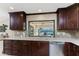 Renovated kitchen with wooden cabinets, stainless steel dishwasher and light countertops at 1339 Casey Key Dr, Punta Gorda, FL 33950