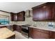Modern kitchen with sleek stainless steel appliances and beautiful mosaic tile backsplash at 1339 Casey Key Dr, Punta Gorda, FL 33950