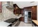 Elegant kitchen boasting stainless steel appliances and dark wood cabinets at 1339 Casey Key Dr, Punta Gorda, FL 33950