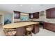 Gourmet kitchen with custom cabinets, stainless steel appliances, and a golden granite island at 1339 Casey Key Dr, Punta Gorda, FL 33950