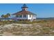 Scenic view of the historic Port Boca Grande Lighthouse nestled in a sandy landscape at 1339 Casey Key Dr, Punta Gorda, FL 33950
