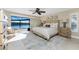 Bright primary bedroom with water view, features a king-size bed and sliding glass doors to outdoor at 1339 Casey Key Dr, Punta Gorda, FL 33950