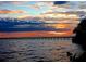 A sunset view overlooking a pier stretching into the water, with colorful clouds at 1339 Casey Key Dr, Punta Gorda, FL 33950