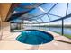 Screened-in pool overlooking the river and lush vegetation at 1339 Casey Key Dr, Punta Gorda, FL 33950