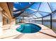 Enclosed pool with great view of the bay, boat lift, and clear blue skies at 1339 Casey Key Dr, Punta Gorda, FL 33950