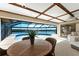 Indoor pool area with dining table, ceiling fan, and river view at 1339 Casey Key Dr, Punta Gorda, FL 33950