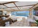 Well-lit sunroom featuring wicker furniture and a large window overlooking the pool and waterfront at 1339 Casey Key Dr, Punta Gorda, FL 33950