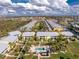 Community aerial view showcasing a pool surrounded by lush landscaping and multiple residences at 2000 Bal Harbor Blvd # 1-111, Punta Gorda, FL 33950