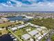 Aerial view of the coastal community featuring meticulously landscaped grounds, a lake, and a marina at 2000 Bal Harbor Blvd # 1-111, Punta Gorda, FL 33950