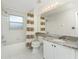 Well-lit bathroom featuring a shower-tub combo with a vanity and a marble countertop at 2000 Bal Harbor Blvd # 1-111, Punta Gorda, FL 33950