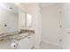 Bright bathroom featuring a marble countertop vanity with double sinks and modern fixtures at 2000 Bal Harbor Blvd # 1-111, Punta Gorda, FL 33950