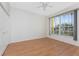 Bright bedroom with wood-look floors, closet and view to the window at 2000 Bal Harbor Blvd # 1-111, Punta Gorda, FL 33950