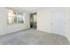 Bright bedroom featuring a large window with palm tree views and a sliding door leading to a balcony at 2000 Bal Harbor Blvd # 1-111, Punta Gorda, FL 33950