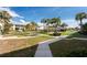Well-manicured community grounds with lush green lawns, mature trees, and inviting walking paths at 2000 Bal Harbor Blvd # 1-111, Punta Gorda, FL 33950