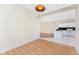 Open-concept dining area with wood floors leading into the kitchen featuring white cabinets and appliances at 2000 Bal Harbor Blvd # 1-111, Punta Gorda, FL 33950