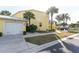 Charming two-story yellow home with a well-manicured lawn and palm tree landscaping at 2000 Bal Harbor Blvd # 1-111, Punta Gorda, FL 33950