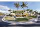 Charming two-story building with vibrant landscaping, mature palm trees, and ample parking at 2000 Bal Harbor Blvd # 1-111, Punta Gorda, FL 33950
