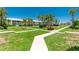 Manicured lawns and walkways among lush landscaping and palm trees in this beautiful community at 2000 Bal Harbor Blvd # 1-111, Punta Gorda, FL 33950