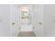 Hallway view of a bathroom with glass shower and white cabinetry at 2000 Bal Harbor Blvd # 1-111, Punta Gorda, FL 33950