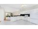 Bright kitchen featuring white appliances and ample counter space, seamlessly flowing into the living area at 2000 Bal Harbor Blvd # 1-111, Punta Gorda, FL 33950