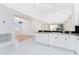 Bright kitchen with white cabinets and granite countertops, seamlessly flowing into the living area at 2000 Bal Harbor Blvd # 1-111, Punta Gorda, FL 33950