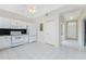 Bright kitchen features white appliances, tile floors, black backsplash, and ample cabinet space at 2000 Bal Harbor Blvd # 1-111, Punta Gorda, FL 33950