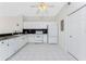 Bright kitchen with white appliances, tile flooring, and ample cabinet space at 2000 Bal Harbor Blvd # 1-111, Punta Gorda, FL 33950