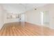 Spacious living room with hardwood floors, neutral walls, and a seamless transition to the kitchen at 2000 Bal Harbor Blvd # 1-111, Punta Gorda, FL 33950