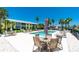 Inviting pool area with plenty of lounge chairs and a dining table for outdoor relaxation and entertainment at 2000 Bal Harbor Blvd # 1-111, Punta Gorda, FL 33950