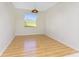 Cozy room featuring laminate wood flooring and a bright window at 2000 Bal Harbor Blvd # 1-111, Punta Gorda, FL 33950