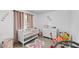 Charming Bedroom with a white crib, light pink accents, and butterfly decor at 2325 Hanford Ln, North Port, FL 34288