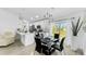 Open-concept dining area with stylish lighting, modern decor, and seamless flow to the kitchen at 2325 Hanford Ln, North Port, FL 34288