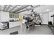 Garage conversion featuring a dining area, kitchenette, laundry area, and lounging space at 2325 Hanford Ln, North Port, FL 34288
