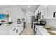 Well-equipped kitchen with modern appliances, ample counter space, and stylish white cabinetry at 2325 Hanford Ln, North Port, FL 34288