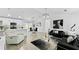 Bright, open-concept living space featuring modern decor, sleek lighting, and seamless flow to the dining area at 2325 Hanford Ln, North Port, FL 34288