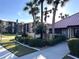 Manicured walkway to the community clubhouse with mature palms and lush landscaping in a beautiful setting at 3006 Caring Way # 409, Port Charlotte, FL 33952