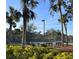 Community tennis courts with mature landscaping and seating for spectators at 3006 Caring Way # 409, Port Charlotte, FL 33952