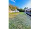 Large, grassy backyard features mature trees and storage shed on property at 4128 Durant St, Port Charlotte, FL 33948