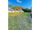 Large, grassy backyard features mature trees and storage shed on property at 4128 Durant St, Port Charlotte, FL 33948
