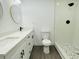 Modern bathroom with double sinks, sleek fixtures, and walk-in shower at 4128 Durant St, Port Charlotte, FL 33948