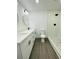 Well-lit bathroom with dual sinks, modern fixtures, toilet, and a shower with neutral-toned tiling at 4128 Durant St, Port Charlotte, FL 33948