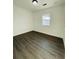 This bedroom features new laminate flooring and lots of light from one window at 4128 Durant St, Port Charlotte, FL 33948