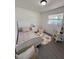 Cozy bedroom with a floral-patterned rug and plenty of natural light at 4128 Durant St, Port Charlotte, FL 33948